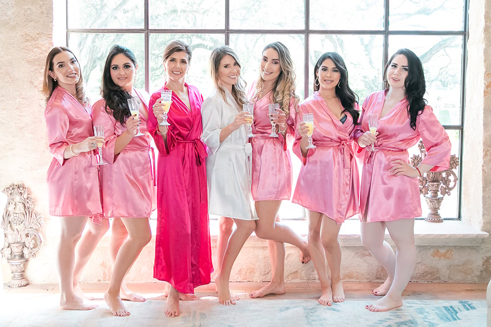 bridesmaids pink robes in bridal suite