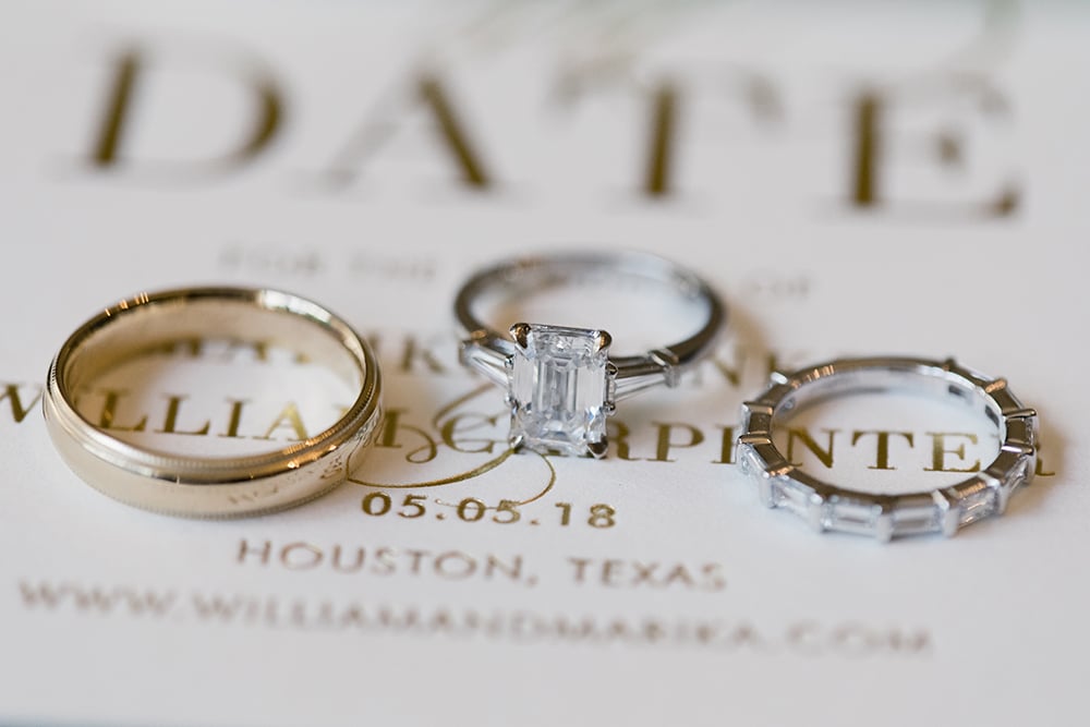 wedding bands and engagement ring on invitations