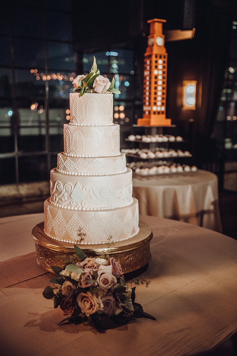 white wedding cake on gold cake stand