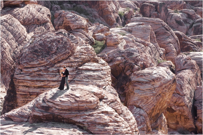 Couple kissing on red rock