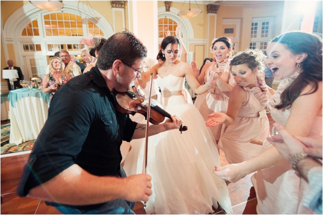 Bridal party dancing with musician