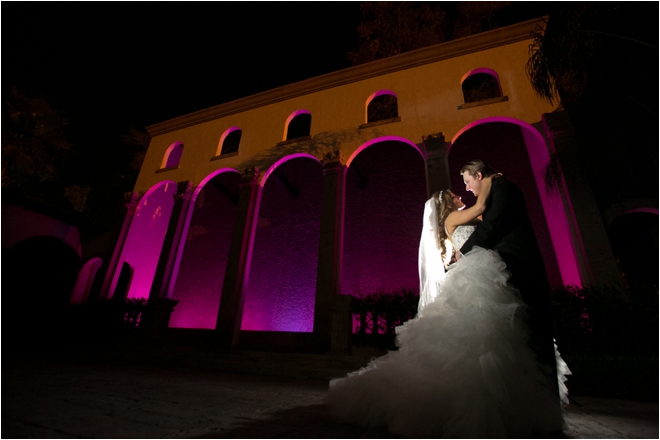 Bride and groom posing outside venue