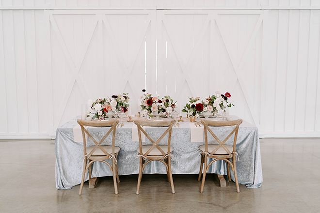 blue linen, velvet linen, floral centerpieces, french bistro chairs, cross back wood chairs, reception decor, wedding, vintage chic, country, farmhouse, texas wedding