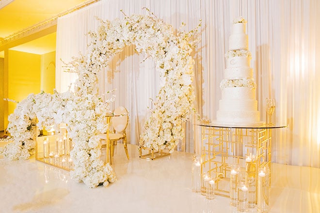 glamorous wedding, reception decor, wedding venue, real wedding, gold, white, ivory, bayou city events center, flowers, floral arch, his her table, elegant, luxury, royal