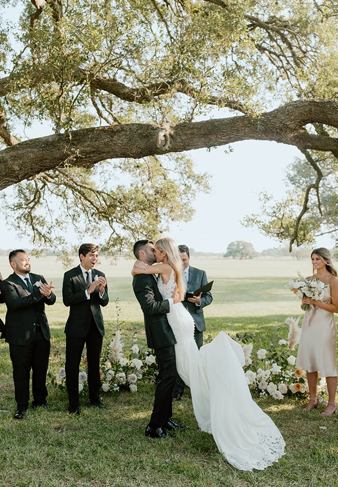 outdoor ceremony, simple, kiss, bride, groom, black, white, champagne