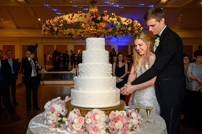 white wedding cake, floral accents, five tiers, susie's cakes, elegant, cutting the cake, reception entertainment