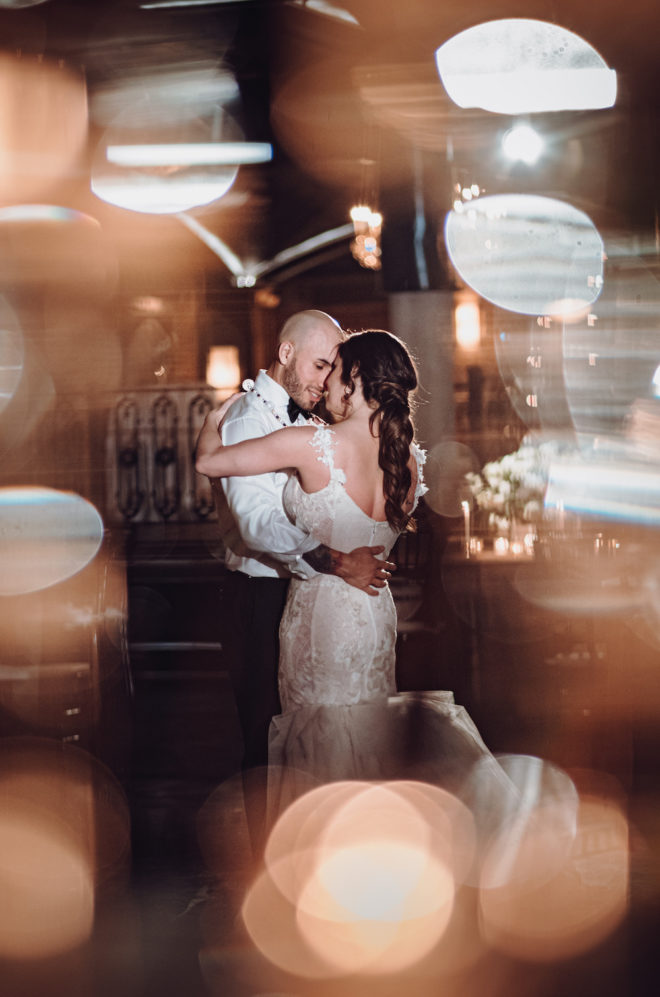 Bride and groom intimate last dance in reception grand hall of industrial chic venue, The Astorian