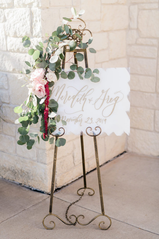 Wedding sign welcoming guests to wedding venue with blush and wine florals. 