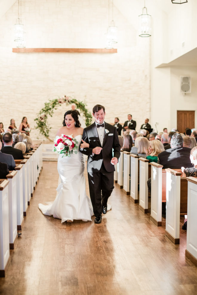 Fall bride and groom walking down the aisle. 