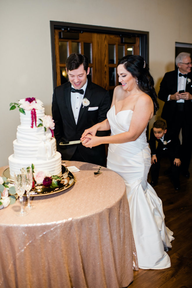 Bride and groom cute blush and wine floral wedding cake. 