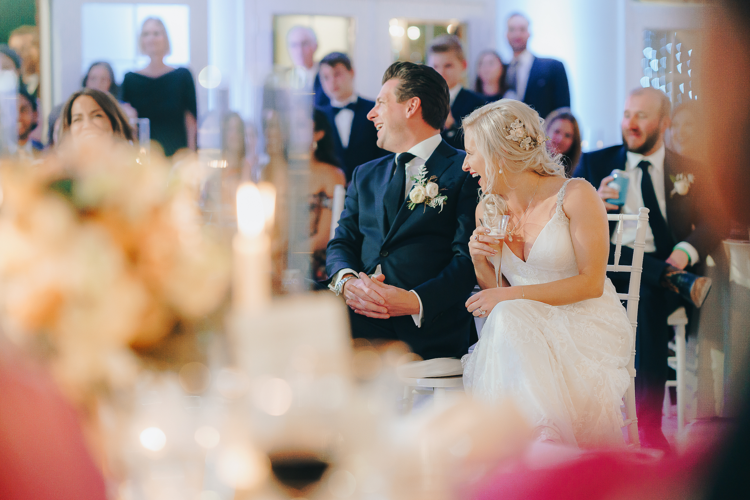 couple sitting and laughing at their reception