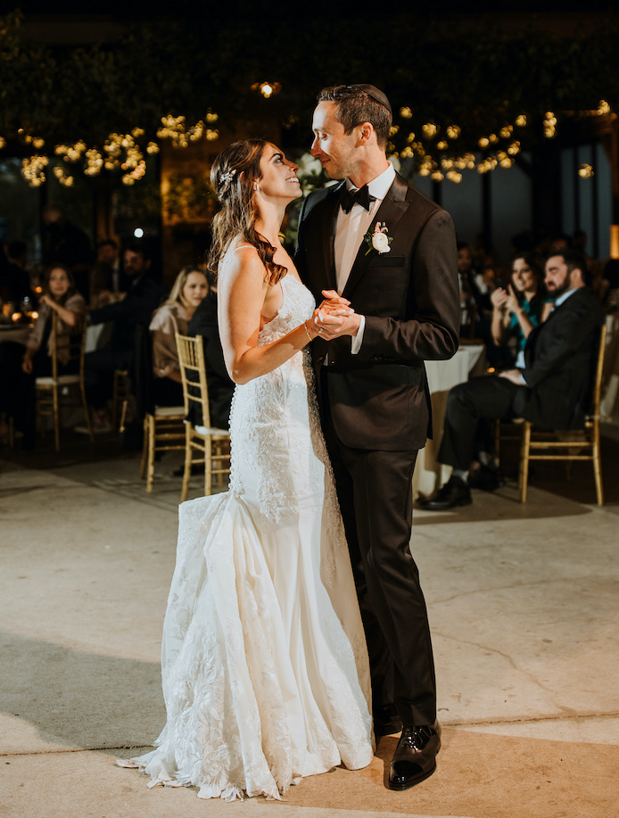 Bride and groom smiling and dancing during their first dance at the ceremony at the Hyatt Regency Lost Pines.
