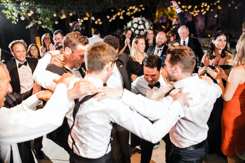 Groom dancing with groomsmen in a circle during the reception at the Hyatt Regency Lost Pines. 