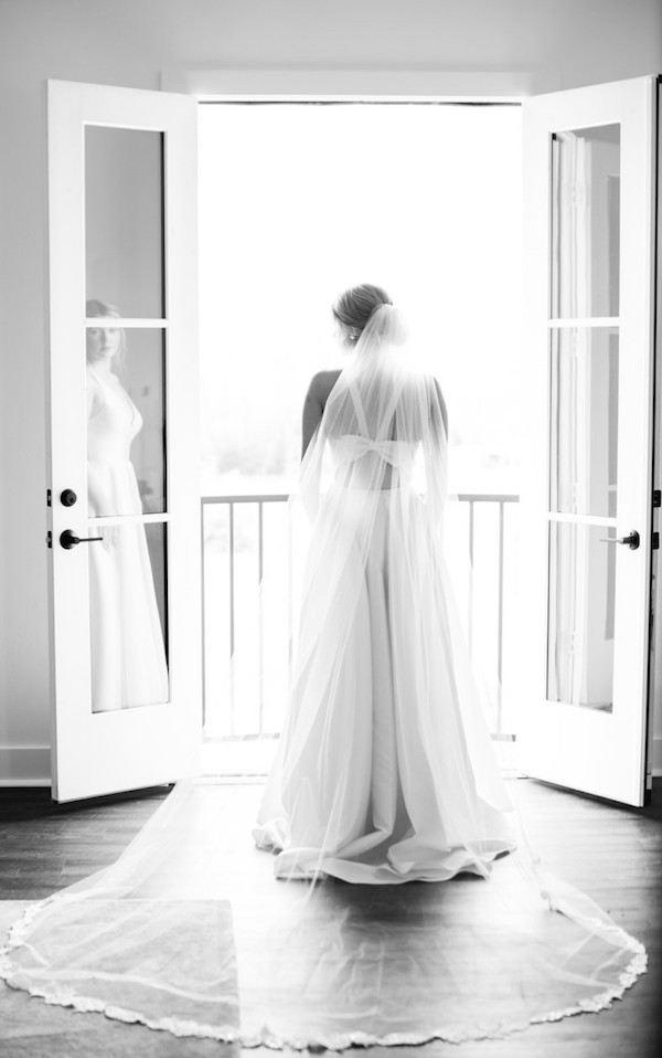 Bride from the back with veil in black and white.