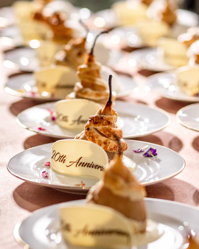 Champagne poached pears stuffed with walnuts and sundried fruits and served alongside local wildflower honey, Creme Anglaise, and honey gelato.