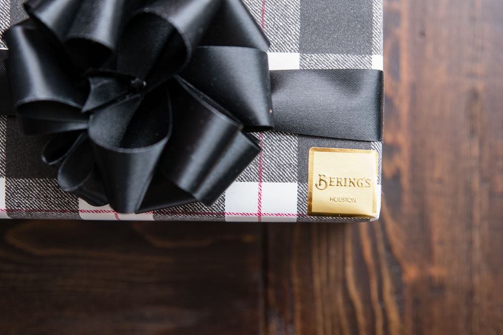 Wedding favors from Bering's wrapped in a black, white, and red plaid paper.
