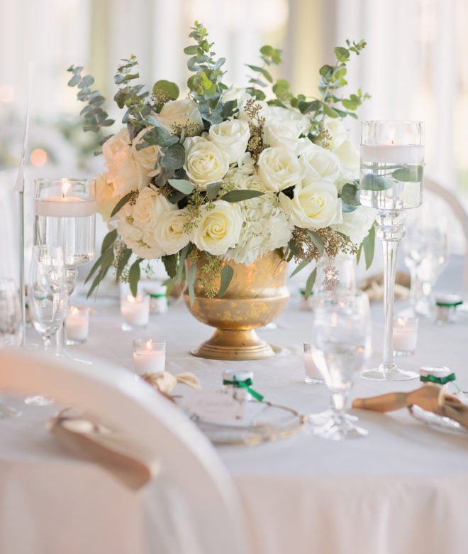 Floral centerpiece in gold urn on a reception table in the Del Lago ballroom of Margaritaville Lake Resort, Lake Conroe