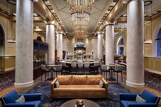 A column lobby with royal blue and gold interior details in downtown Houston Hotel Icon.