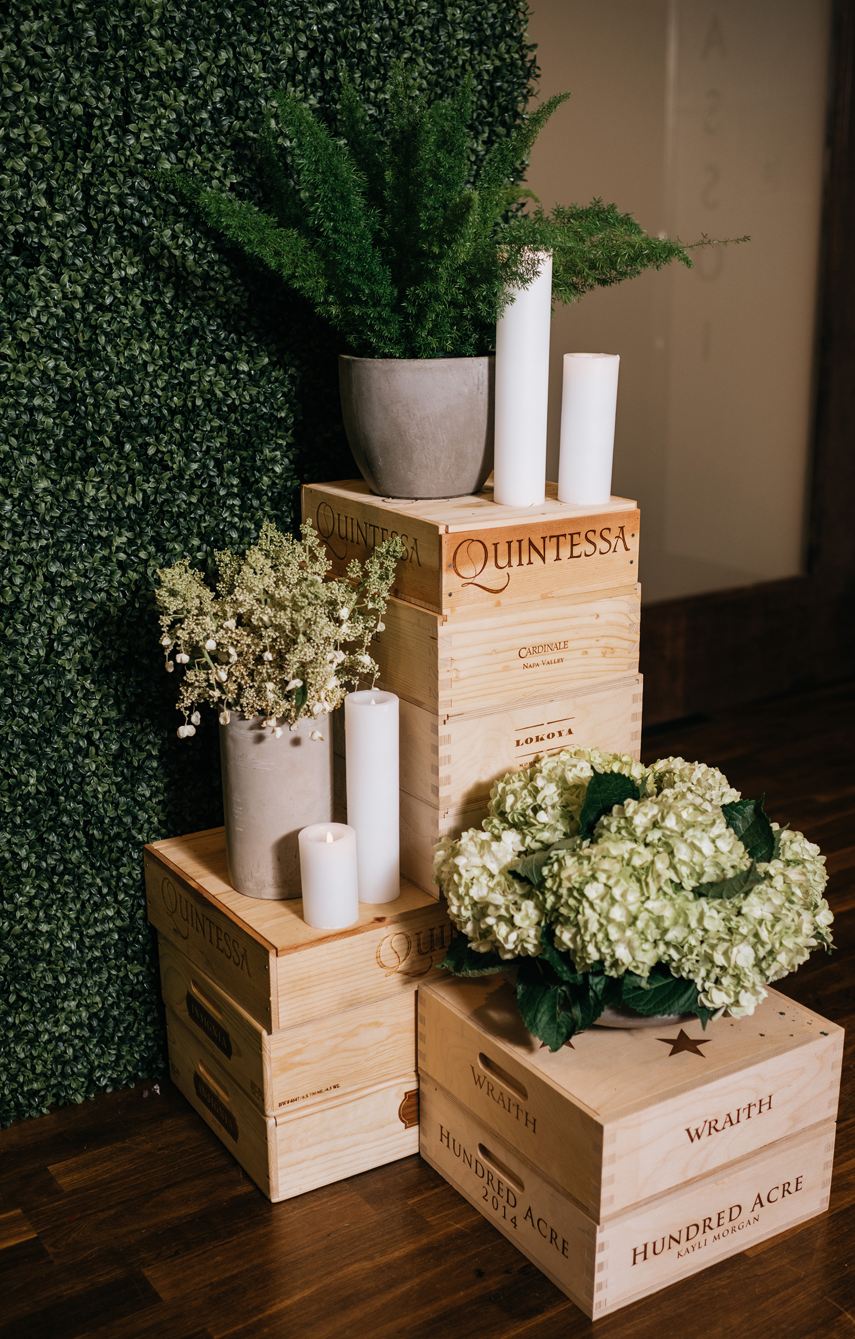 Wine barrels act as wedding decor with the greenery.