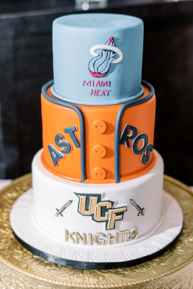 Groom's three-tiered cake with classic sports jerseys as each layer.
