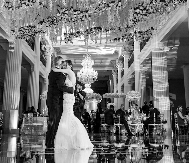 Bride holds on to her father while the two dance in a father daughter dance in the center of the ballroom at the Corinthian Houston. 