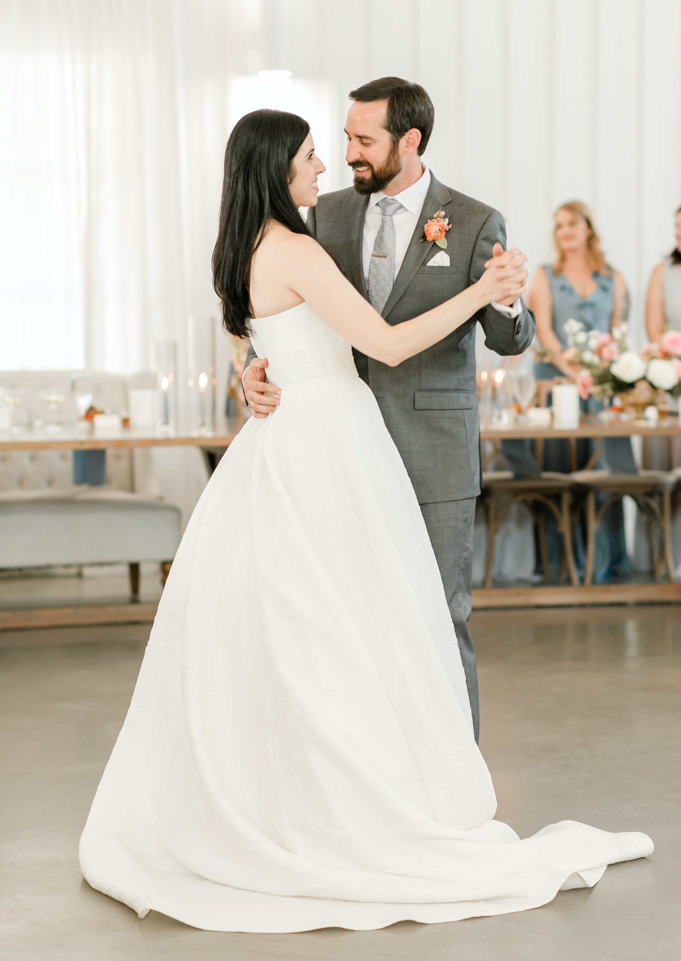 The bride and groom dance in the reception room.