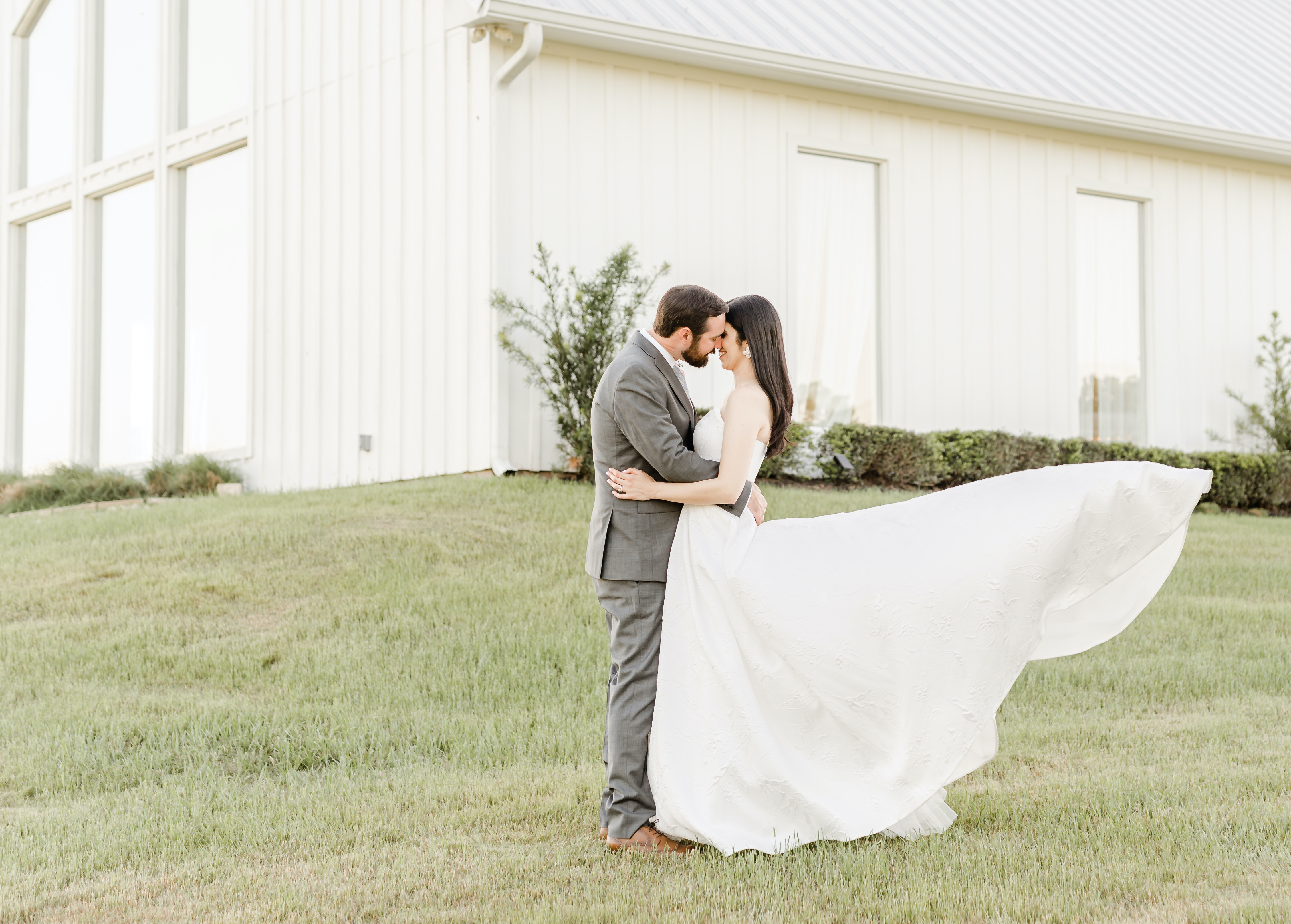 The bride and groom are about to kiss in front of their wedding chapel.