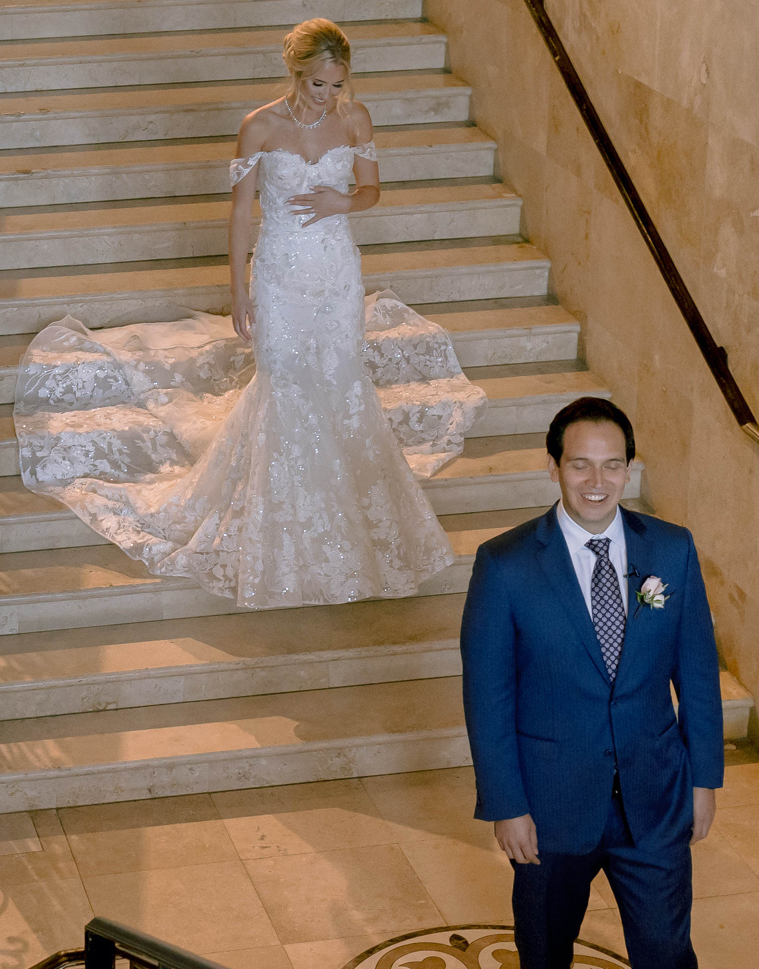 The bride and groom do their first look before the greenery-filled wedding.