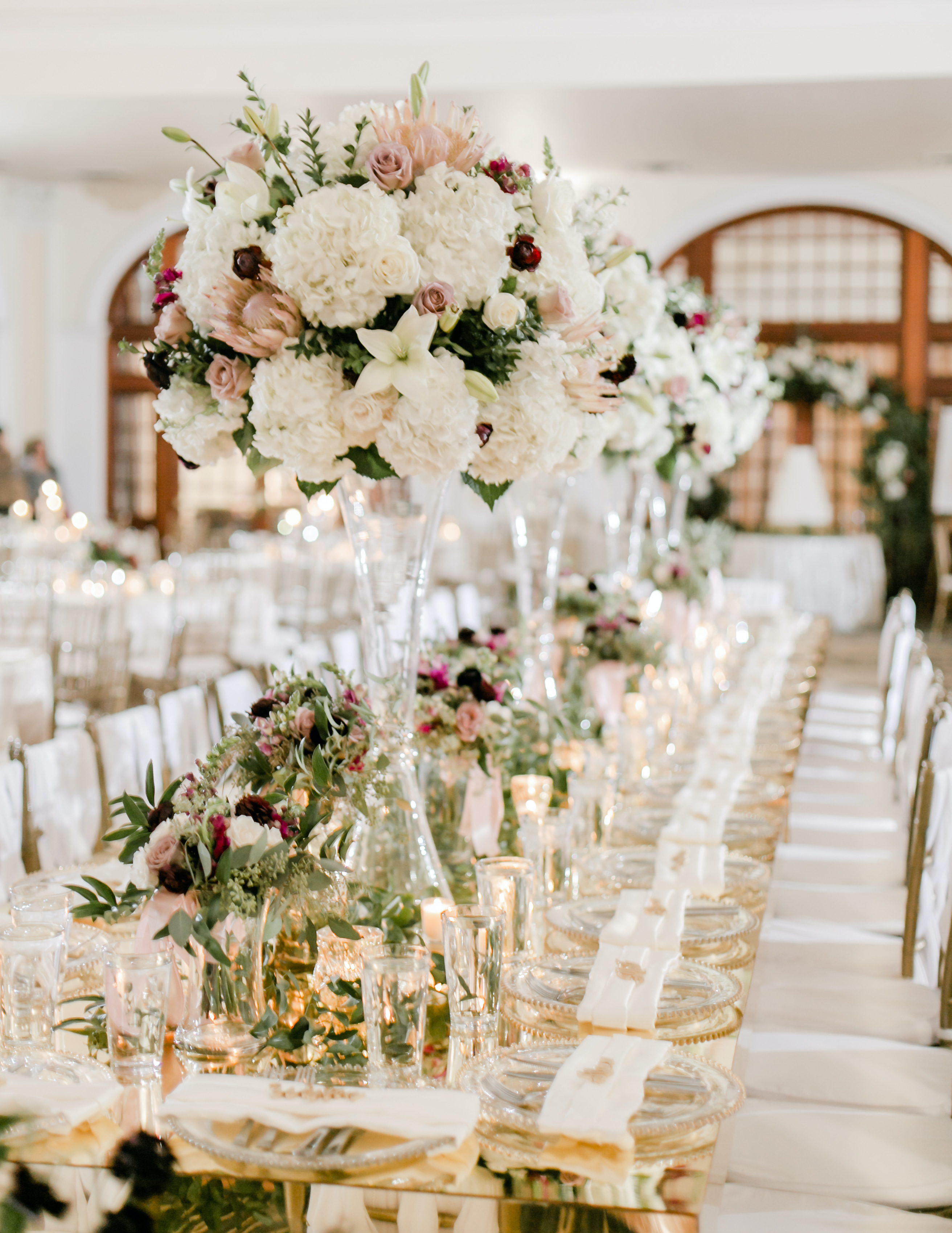 Interior photo of the Crystal Ballroom and a wedding white floral filled reception tablescape.