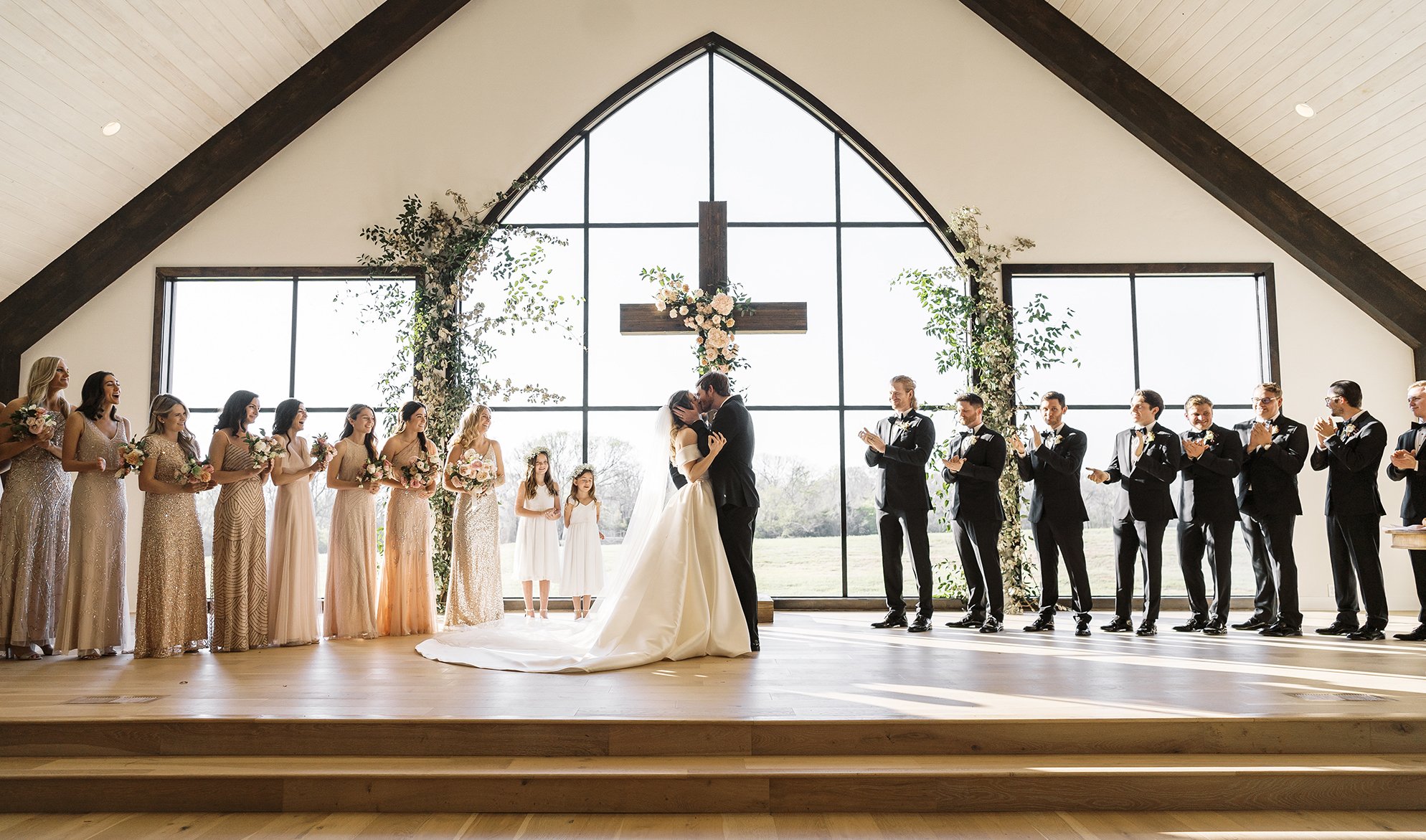 The bride and groom kiss at the alter.