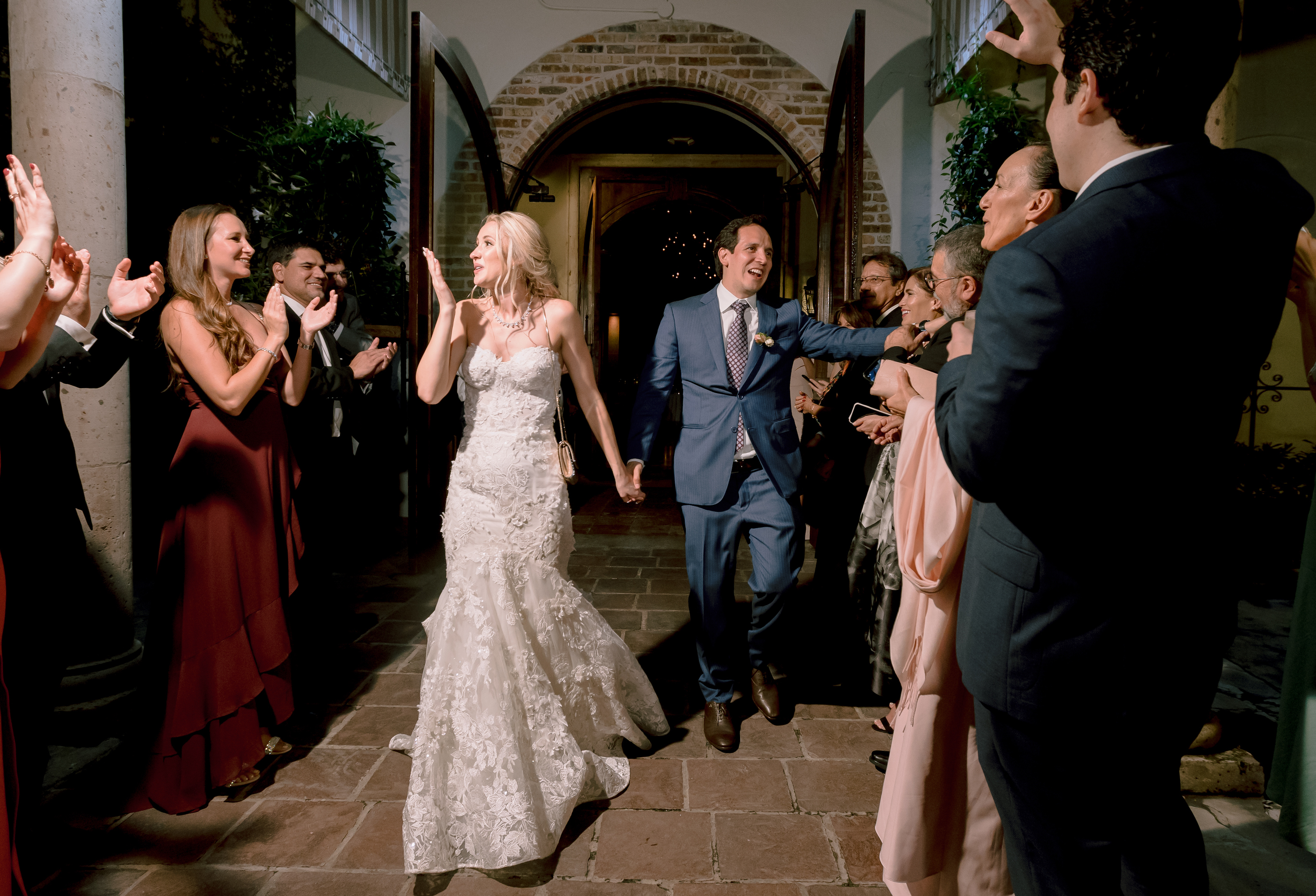 The bride and groom waving goodbye at their send-off.