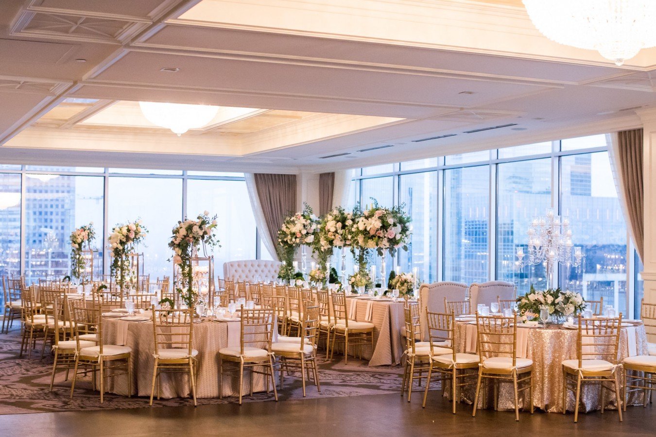 A flower filled reception with a sky view wedding venue in The Petroleum Club in Downtown Houston