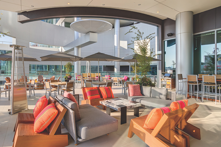 The colorful modern covered outdoor patio of Pinstripes Houston.