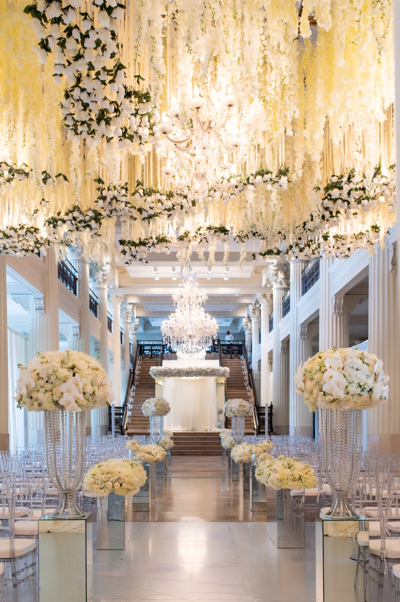 Ceiling hanging white floral decor for a traditional wedding in The Corinthian Houston.