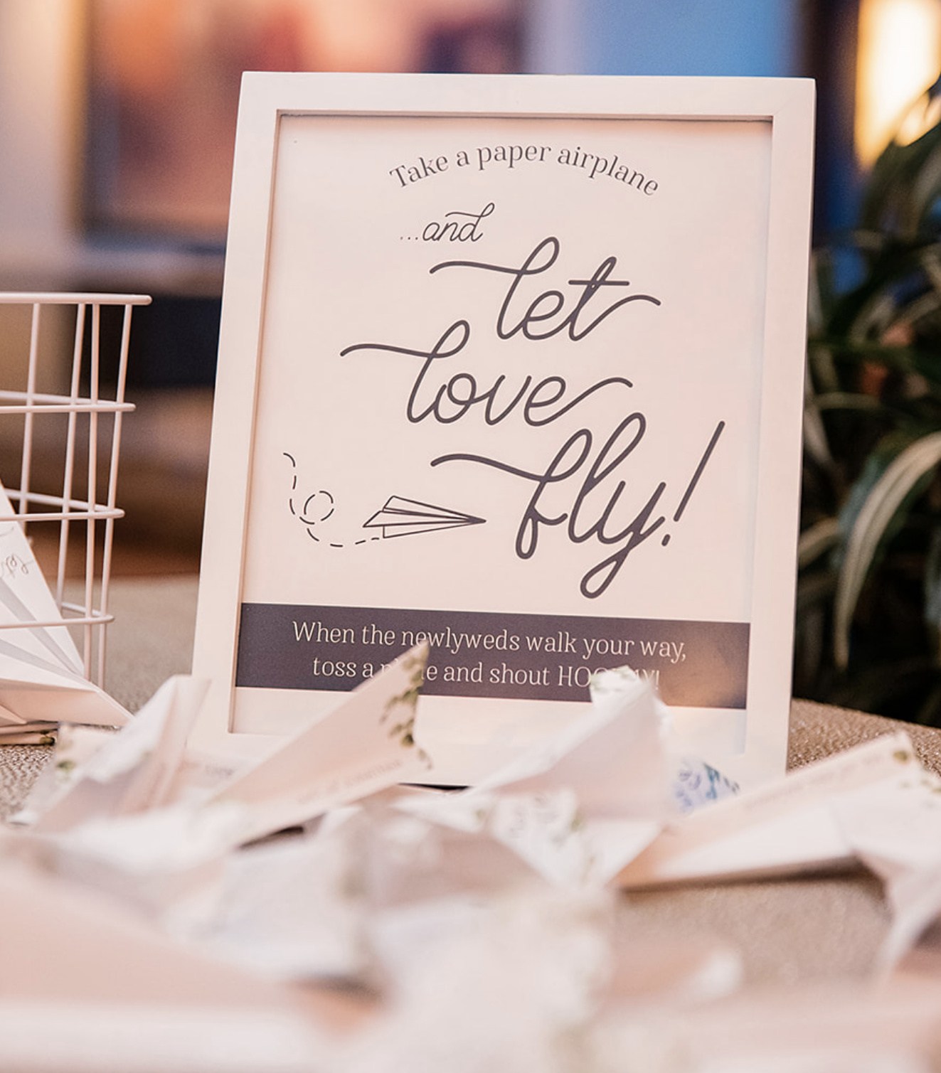 A wedding guest entrance idea, where guests fly a paper airplane to the bride and groom with a note.