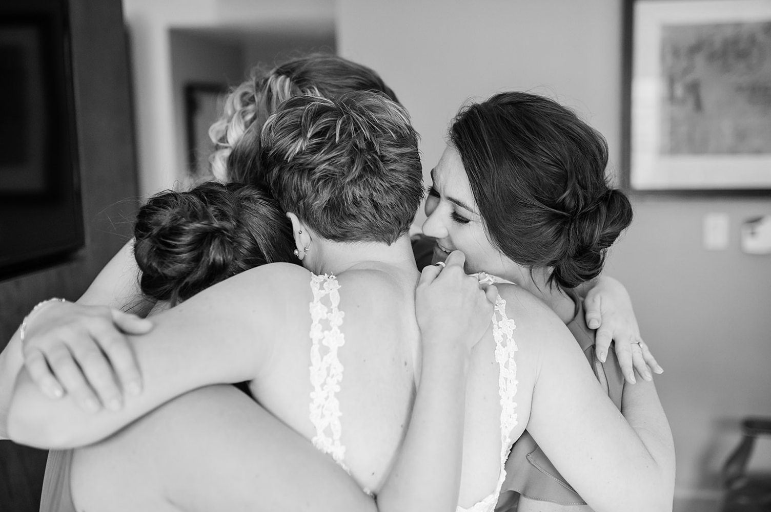 The bride hugs two of her bridesmaids before the whimsical jewel-toned wedding.