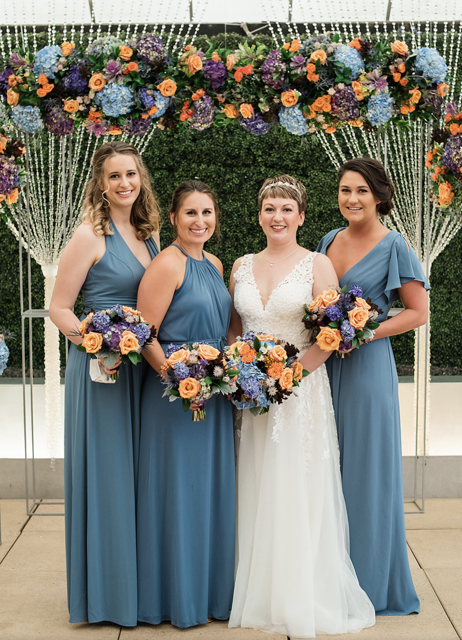 The bride smiles with her bridesmaids beside her at the Sam Houston Hotel at the Veranda