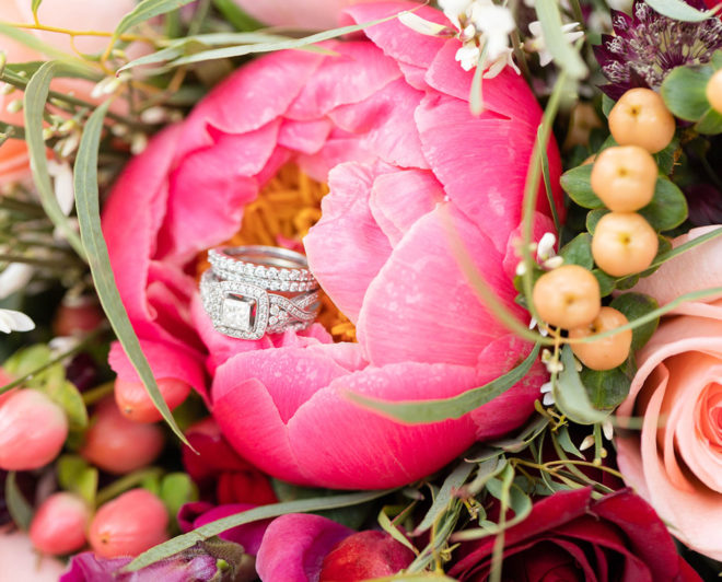 Bridal bouquet with pink peonies, roses and greenery with engagement ring and wedding band in the center of a flower at a wedding styled shoot at The Kendall Hill Country Inn in Boerne, Texas. 