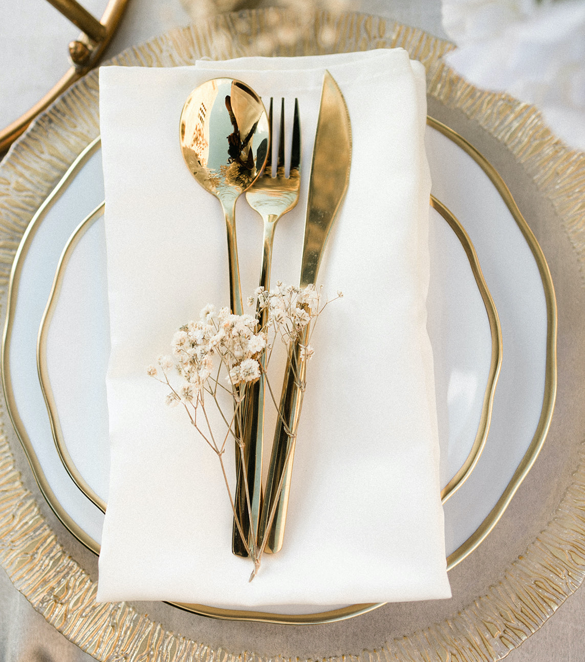 An up-close photo of the gold dinnerware used for the ethereal rooftop wedding styled shoot.