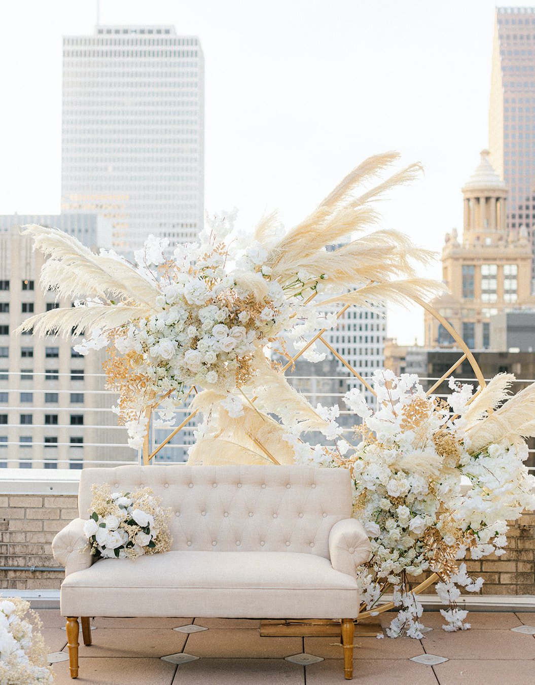 A couch is decorated for the ethereal rooftop wedding styled shoot.