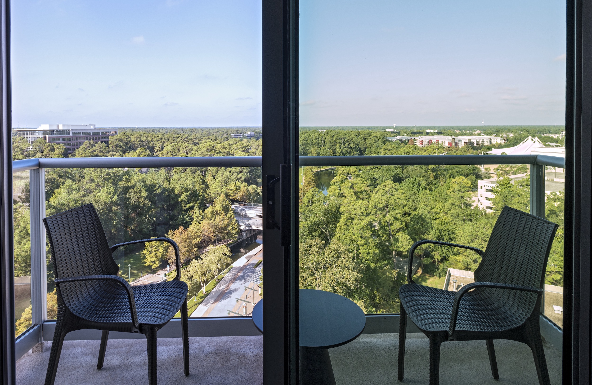 A king balcony view that is waterfront and overlooks The Cynthia Woods Mitchell Pavilion.