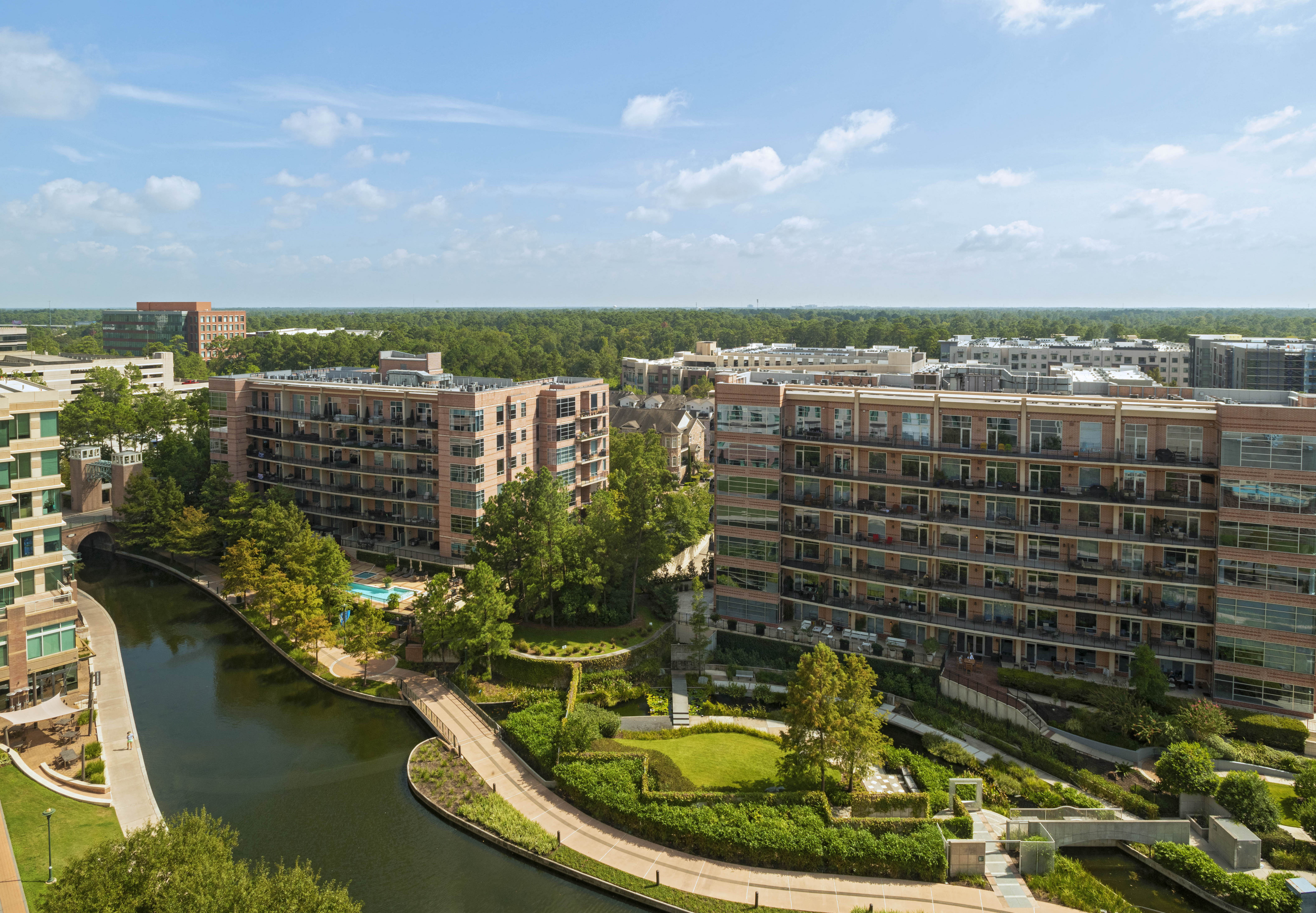 View of the Woodlands Waterway canal and apartment buildings from a guest room.