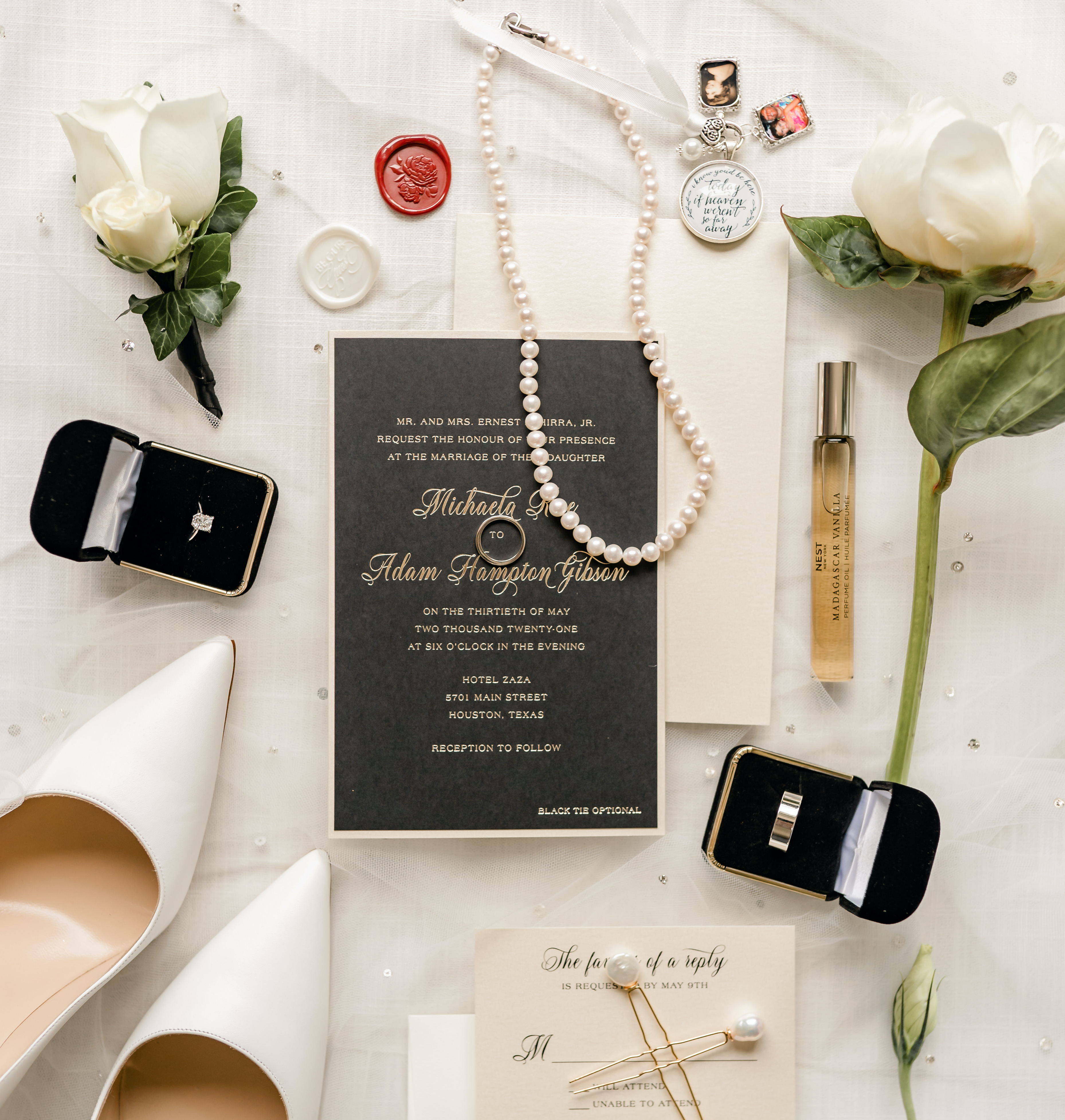 A flat lay with black, ivory and champagne accents for a wedding in the museum district.