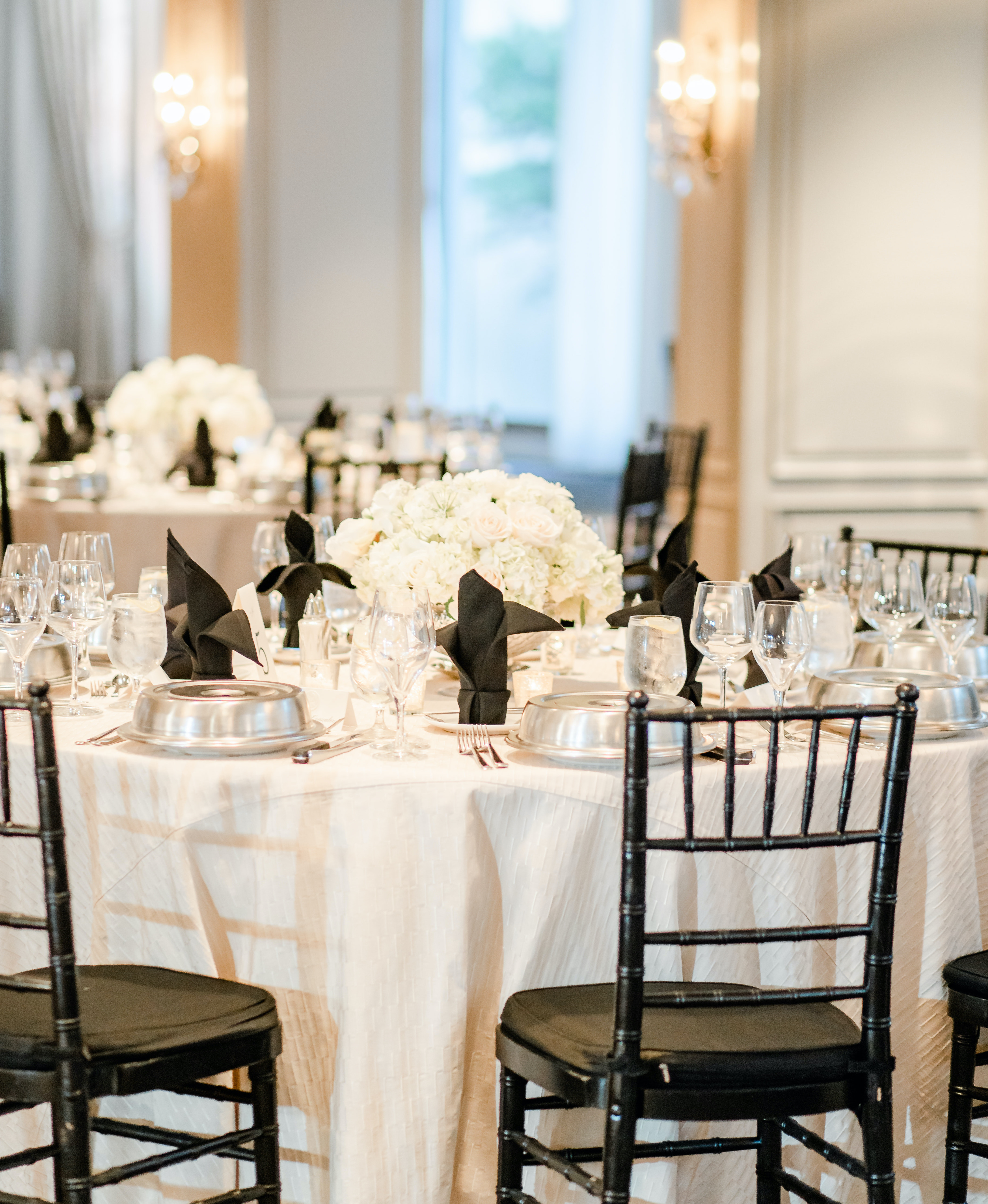 A reception table is set for a black, ivory and champagne wedding in the Houston museum district.