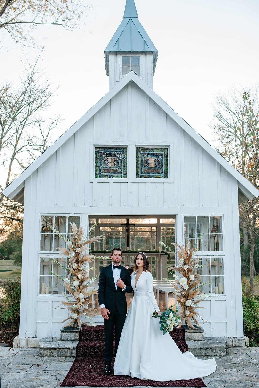 The bride and groom stand in front of the outdoor chapel in College Station, TX at 7F Lodge.