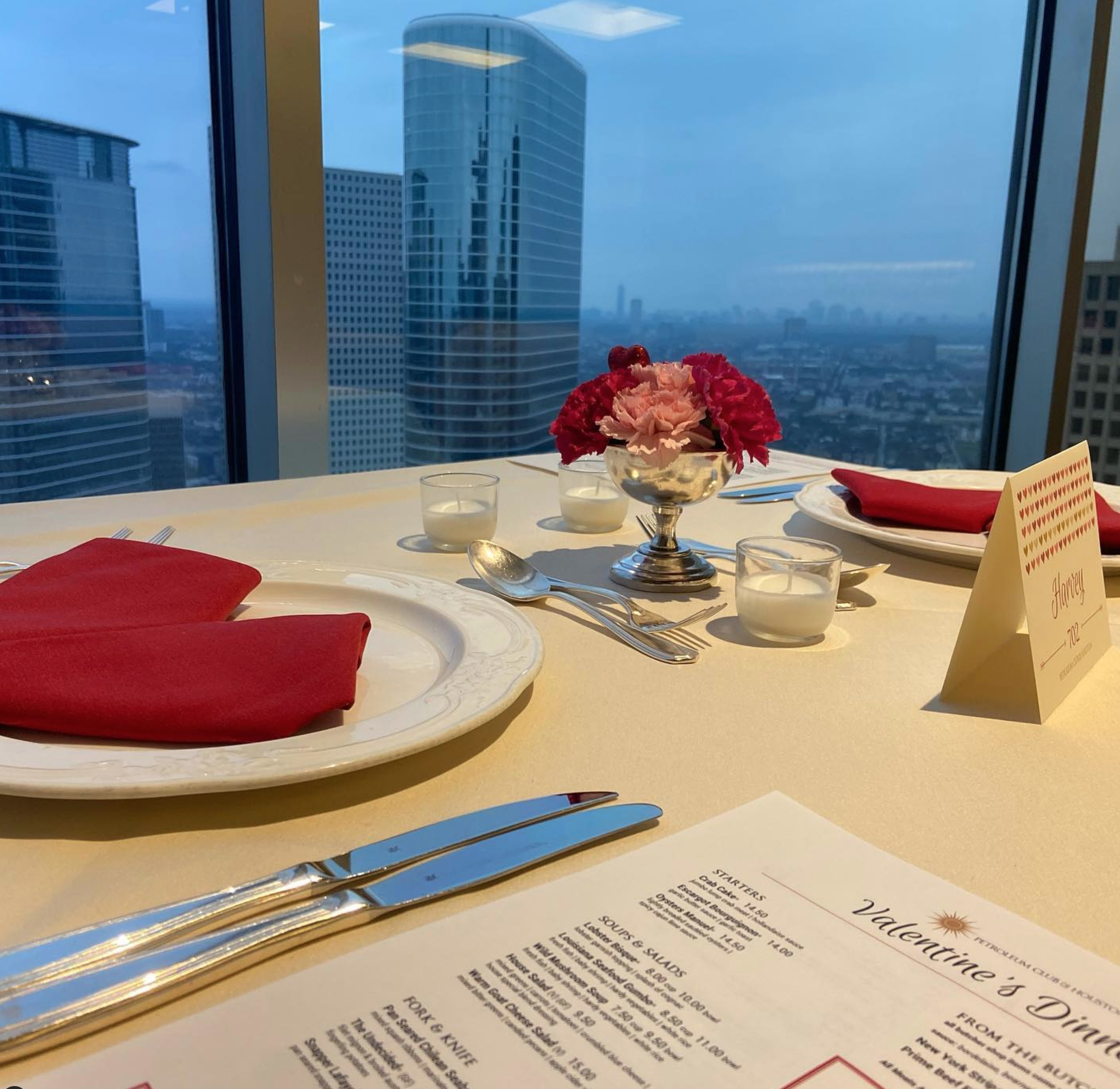 A luxurious Valentine's Day dinner set-up at the Petroleum Club of Houston in Houston, TX. The table is overlooking the city.