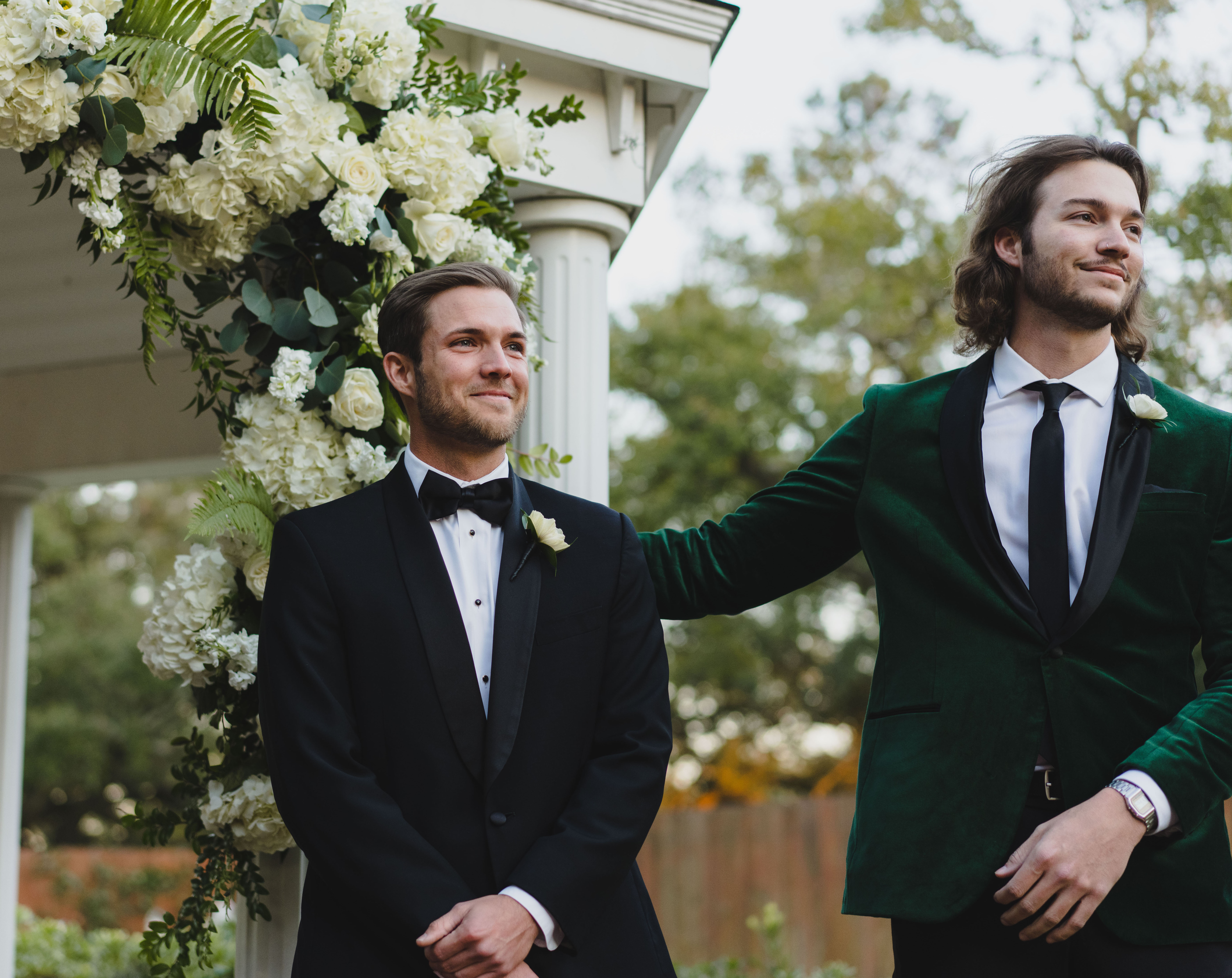 Jordan Kimball smiles as his bride walks down the aisle of their outdoor ceremony in Houston, TX.