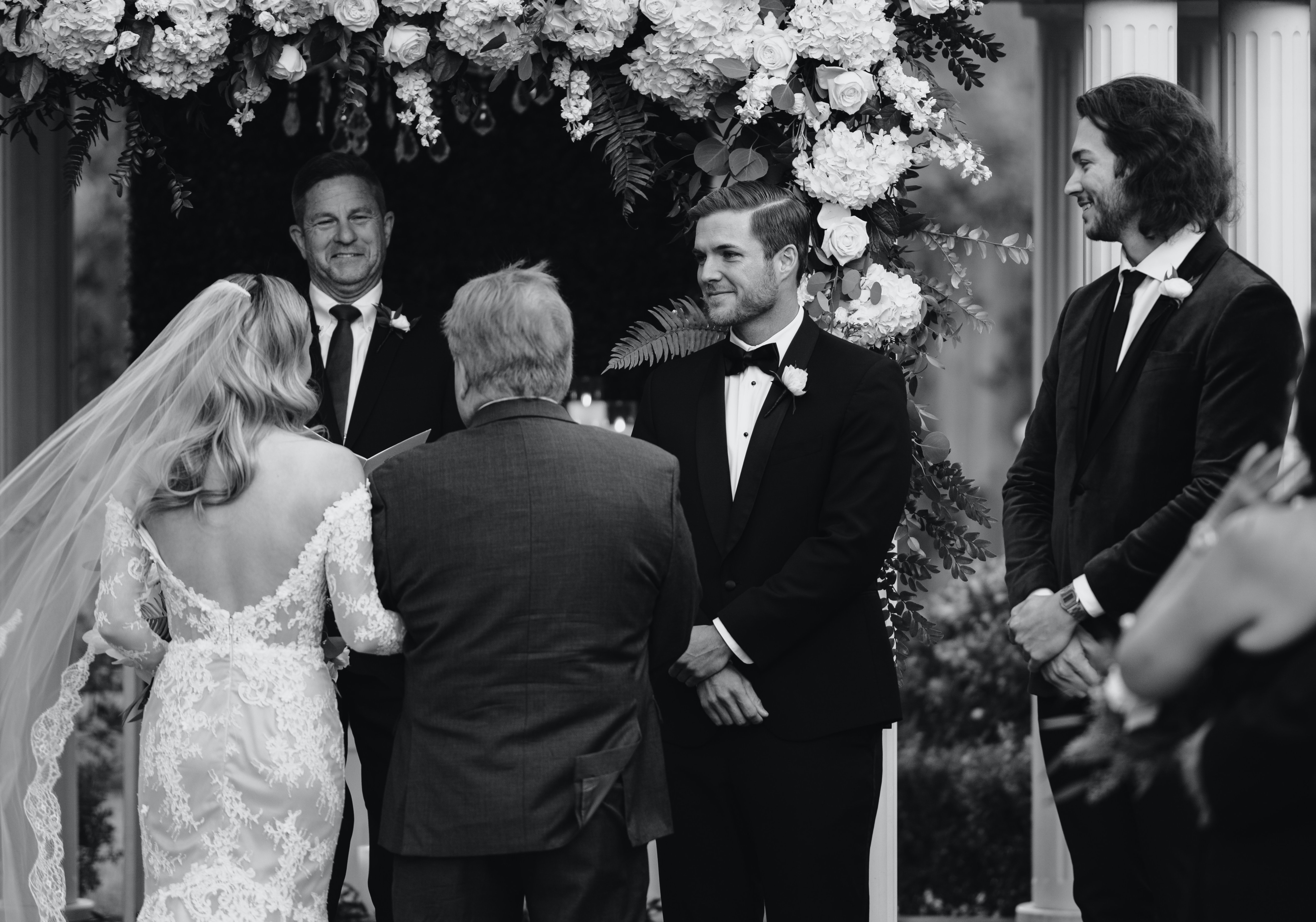 Christina Creedon meets her groom, Jordan Kimball, at the altar of their outdoor wedding in Houston, TX.