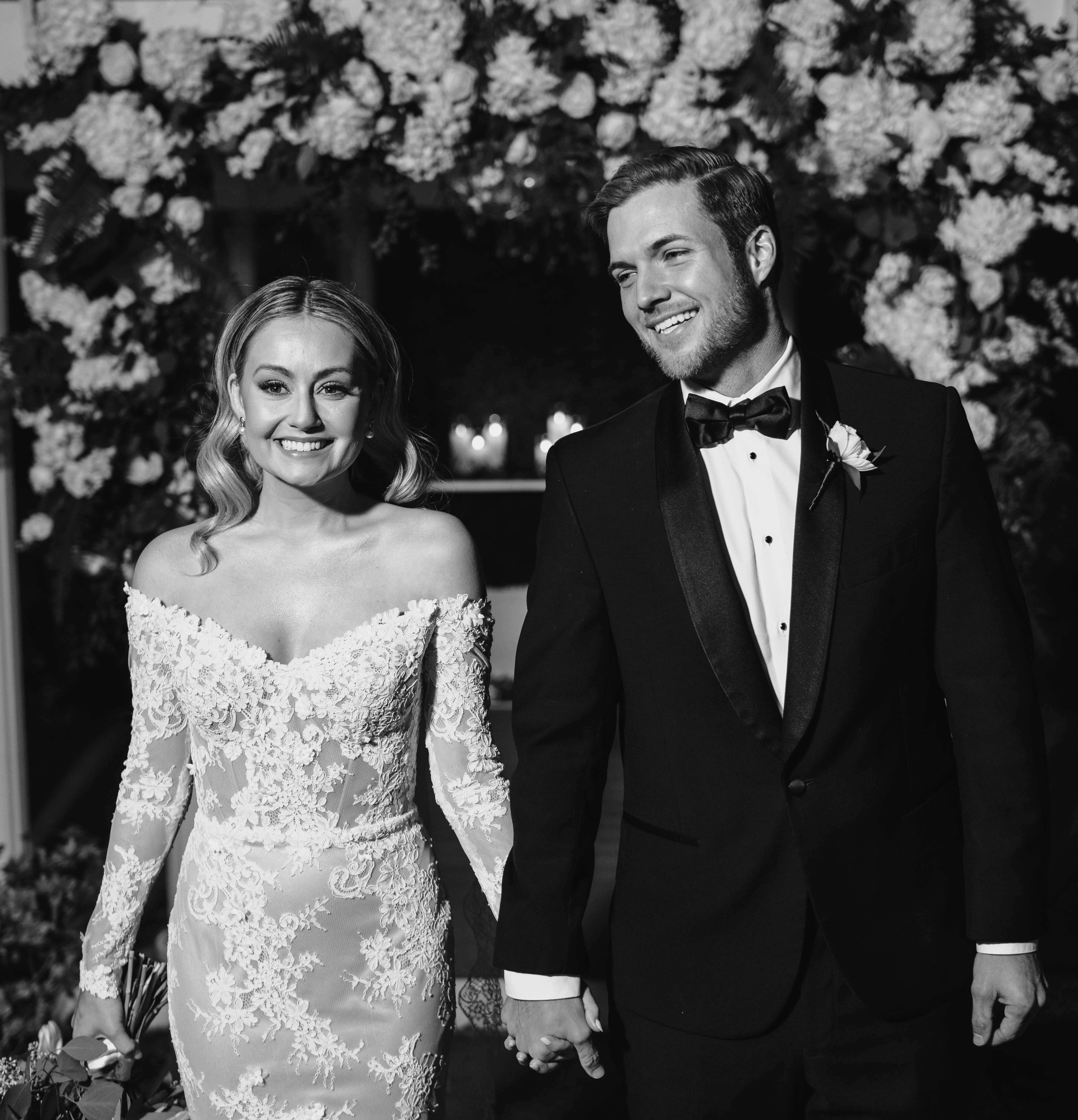 A black and white photo of Jordan Kimball and his wife at their outdoor wedding ceremony in Houston, TX at The Wynden.