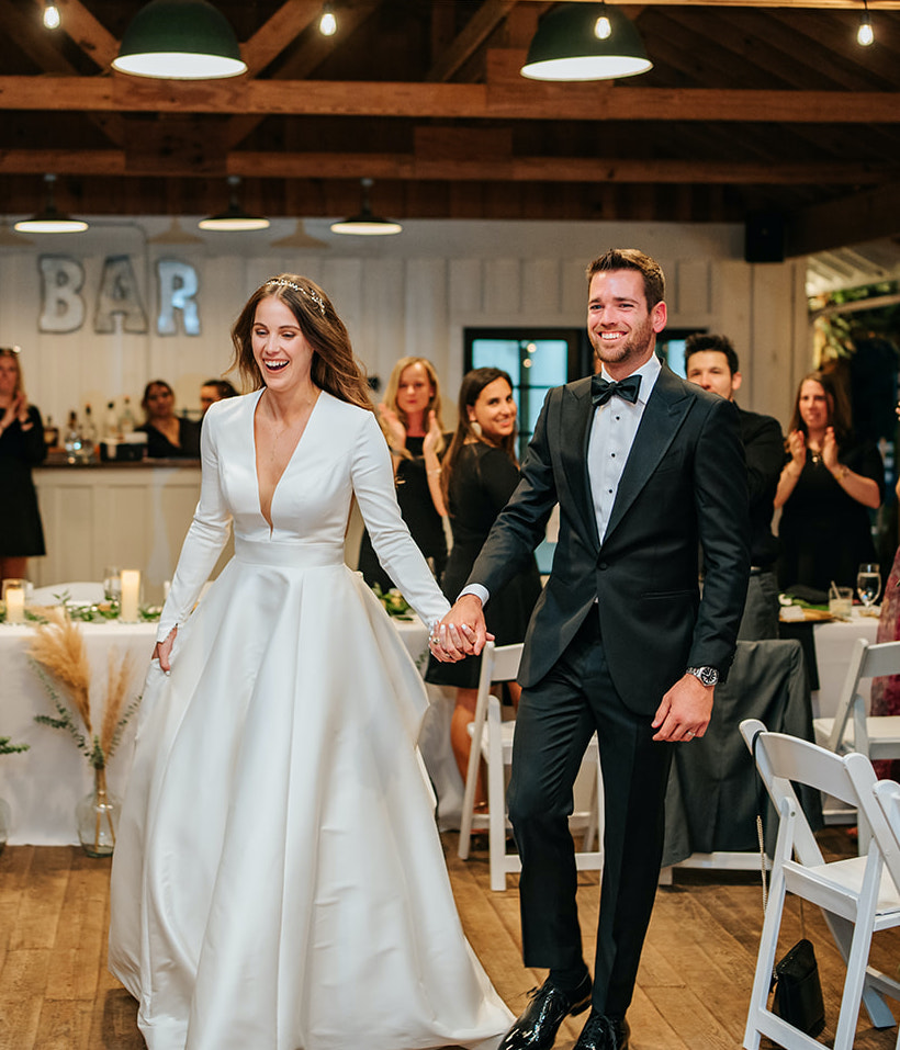 The bride and groom make their entrance to their reception at 7F Lodge in College Station, TX.